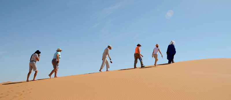 walking in the sand dunes in Erg Chebbi Morocco