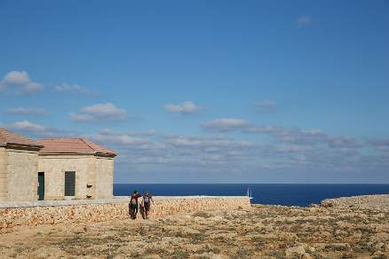 Walking past the lighthouse of Point Niti Menorca Spain